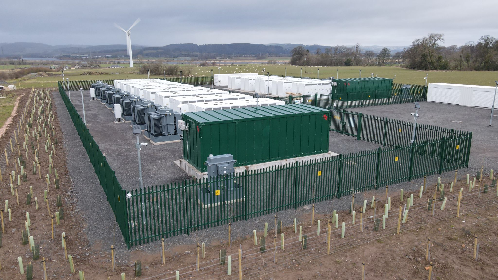 An image of storage containers in a field. Jamesfield-BESS-project-in-Scotland-UK